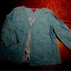 This is a unique blazer that's embroidered and satin. Aqua in color vintage